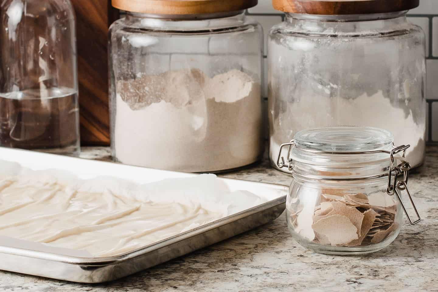 A baking sheet and a jar with dried sourdough starter.