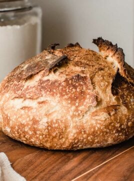 A loaf of sourdough bread on a cutting board.