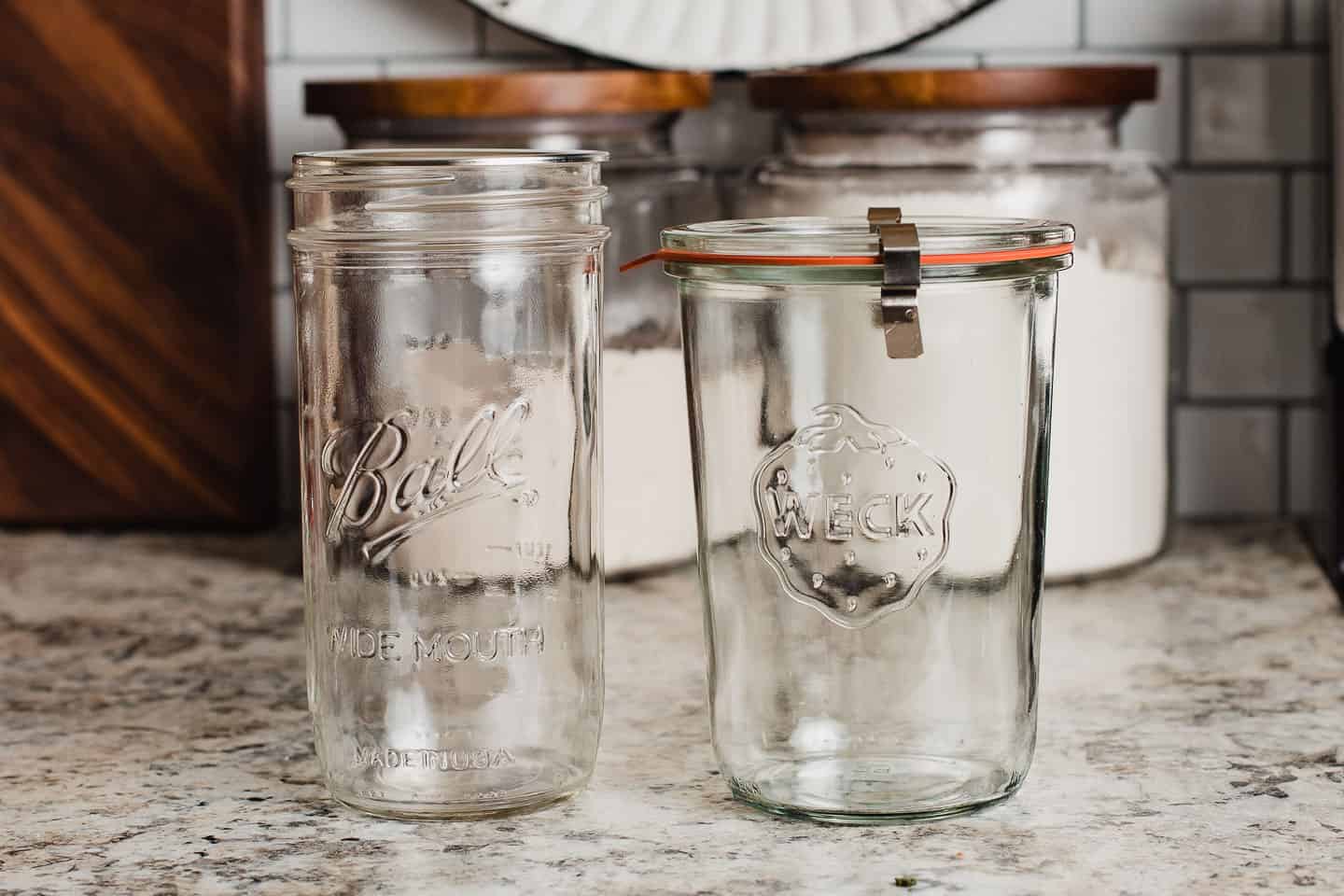 Two glass containers on a counter top.