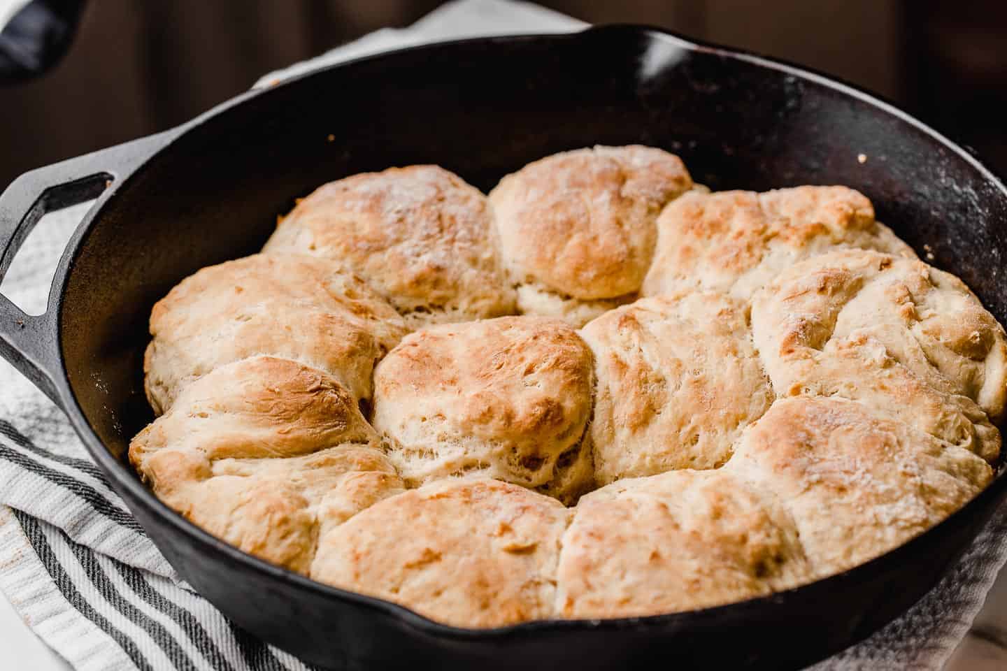 Cast iron skillet with baked sourdough biscuits.