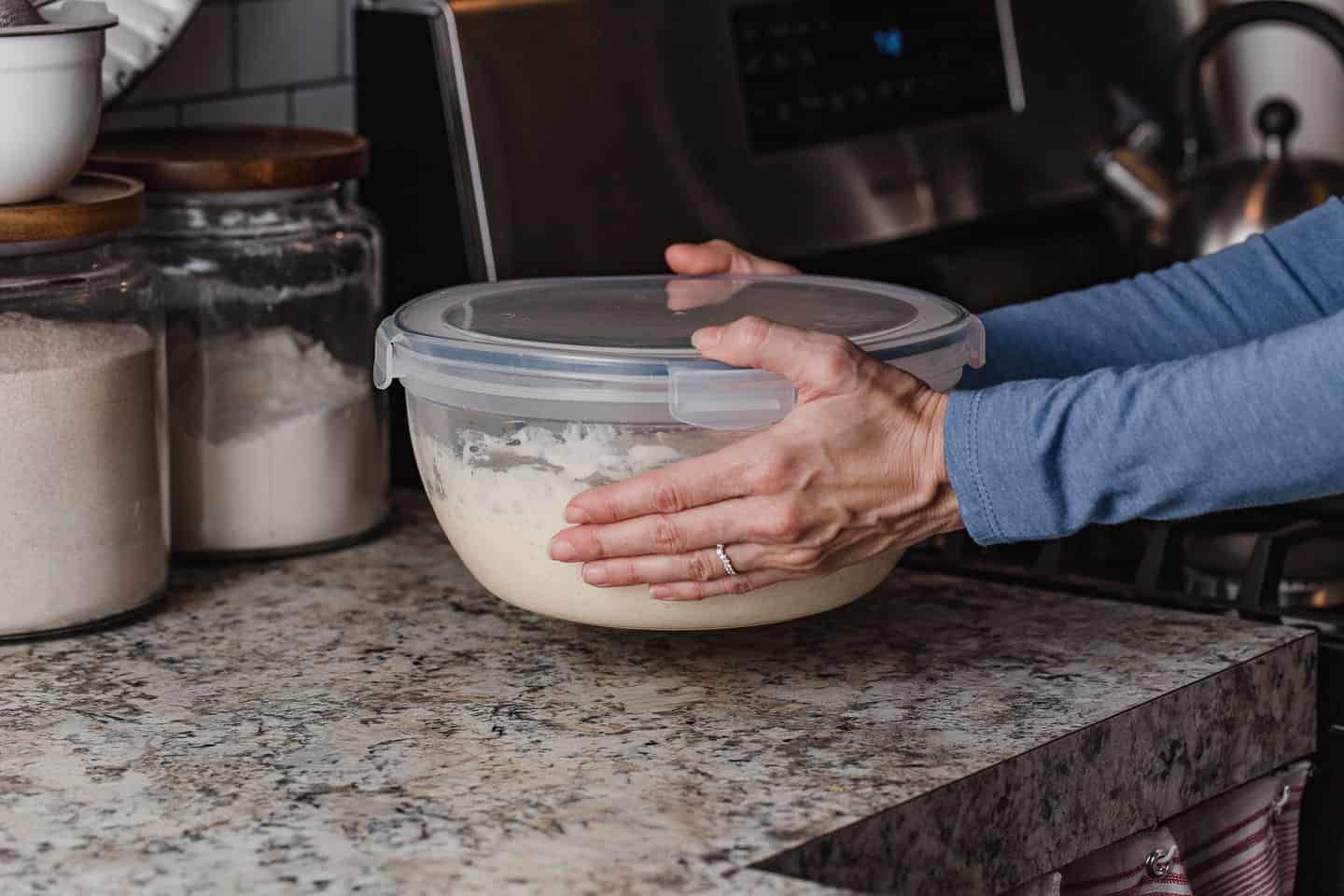 A woman setting a bowl on the counter.
