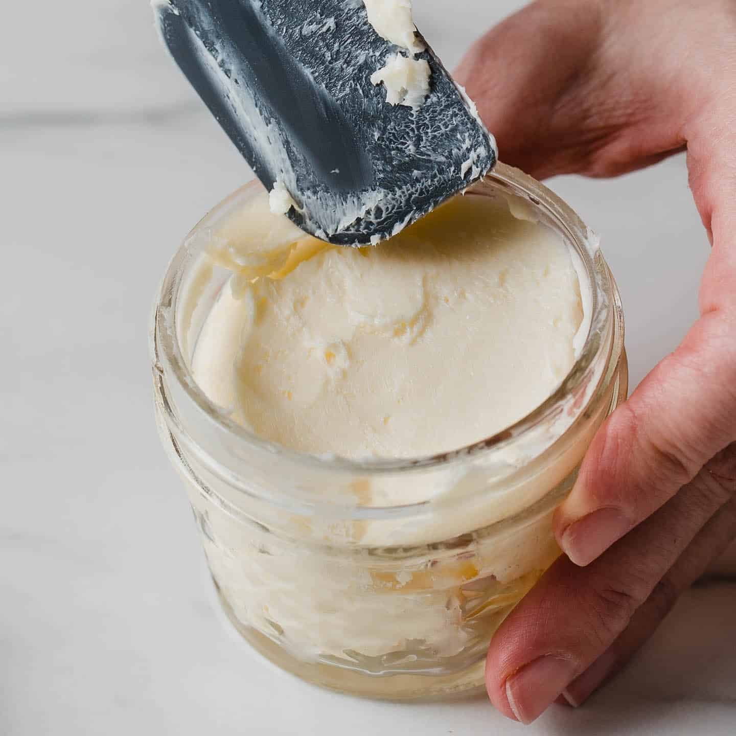 Homemade butter in a small glass jar.