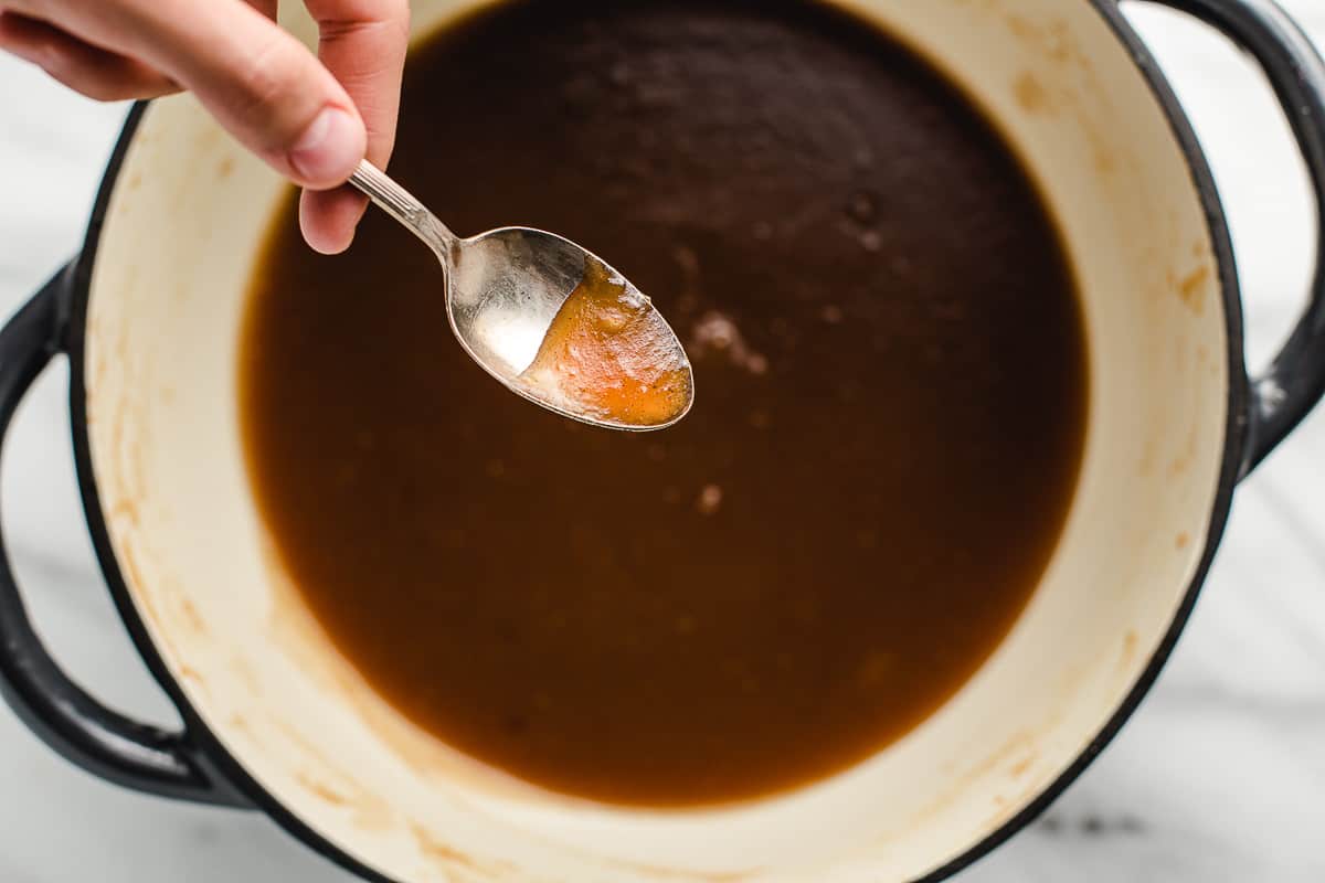 Apple butter sticking to the back of a spoon to show it's doneness.