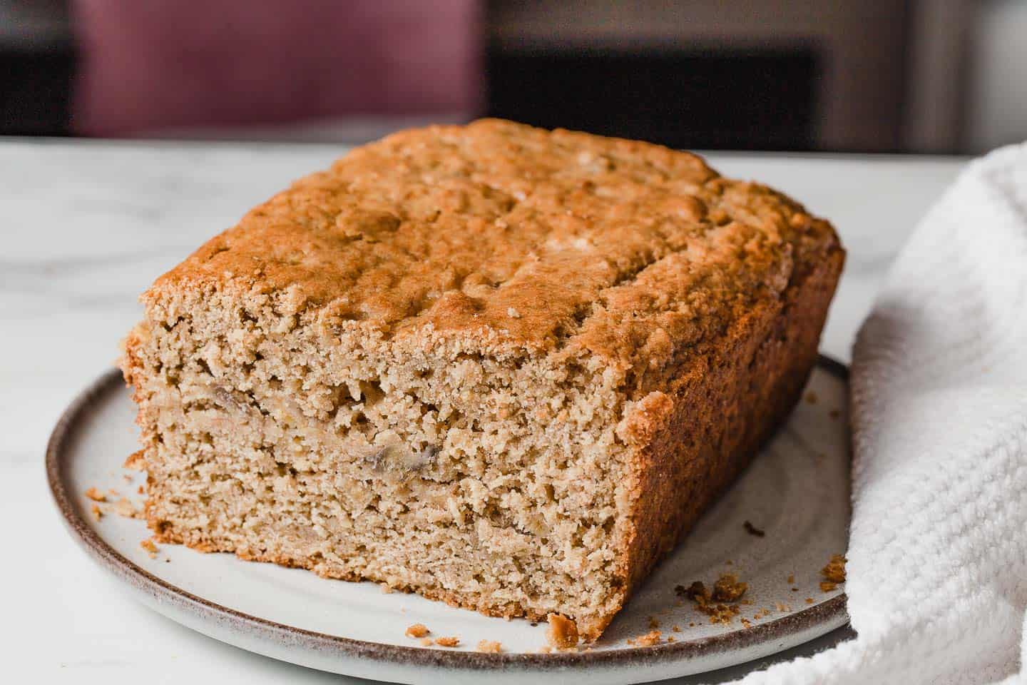 A loaf of sourdough banana bread on a plate.