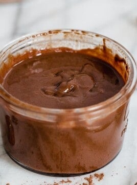 A glass jar filled with homemade nutella spread.