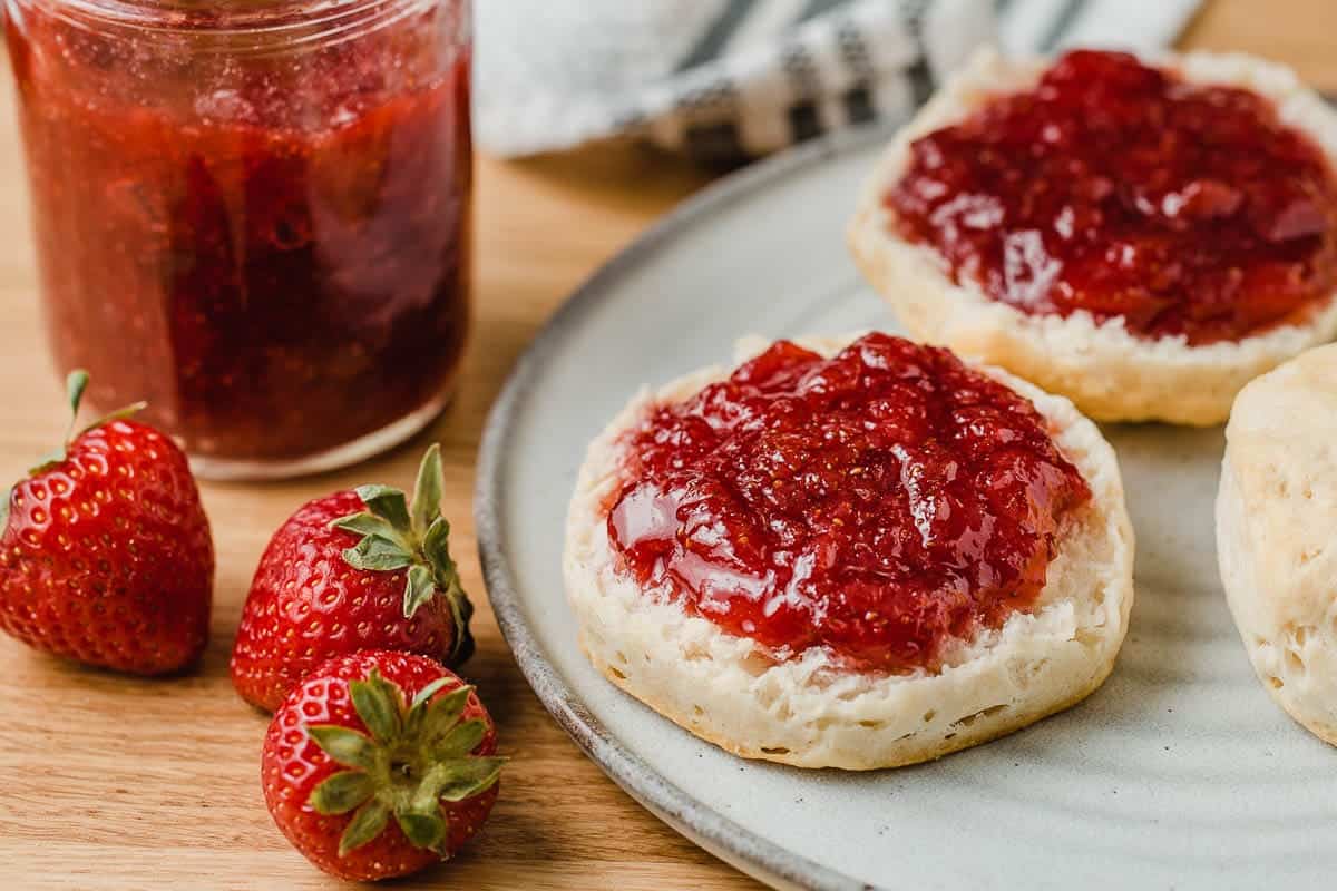 Fresh strawberry jam on a biscuit.