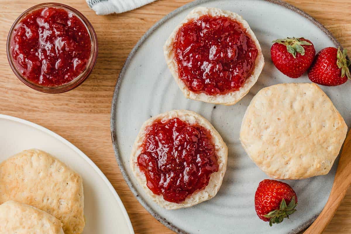 Strawberry jam spread on baked biscuits.