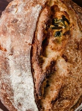 Jalapeno cheddar sourdough bread on a cutting board.