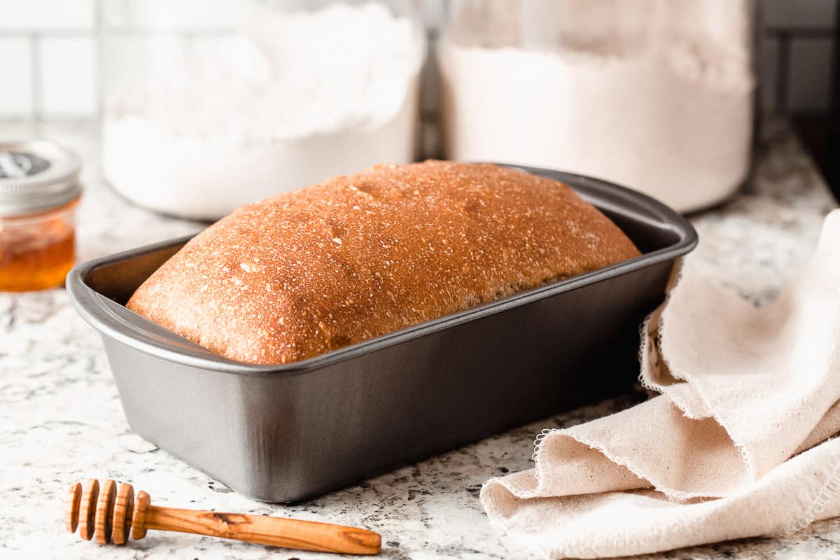 https://littlespoonfarm.com/wp-content/uploads/2020/10/honey-wheat-sourdough-sandwich-bread-loaf-in-a-pan-on-counter.jpg
