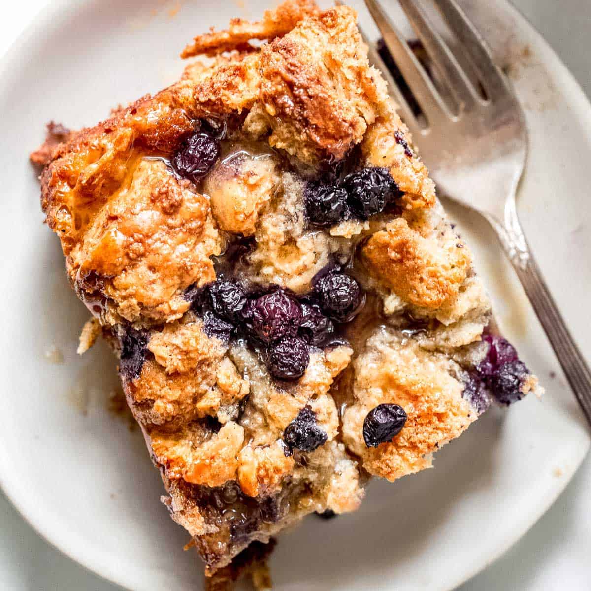 Blueberry bread pudding on a plate.