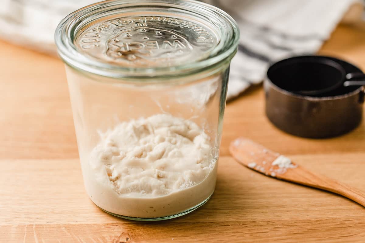 Brown rice flour and water mixed together in a glass jar.
