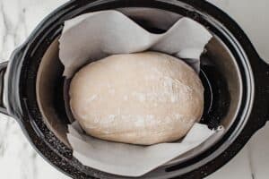Dough placed in slow cooker liner.