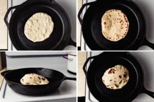 Sourdough naan cooking in a cast iron skillet.