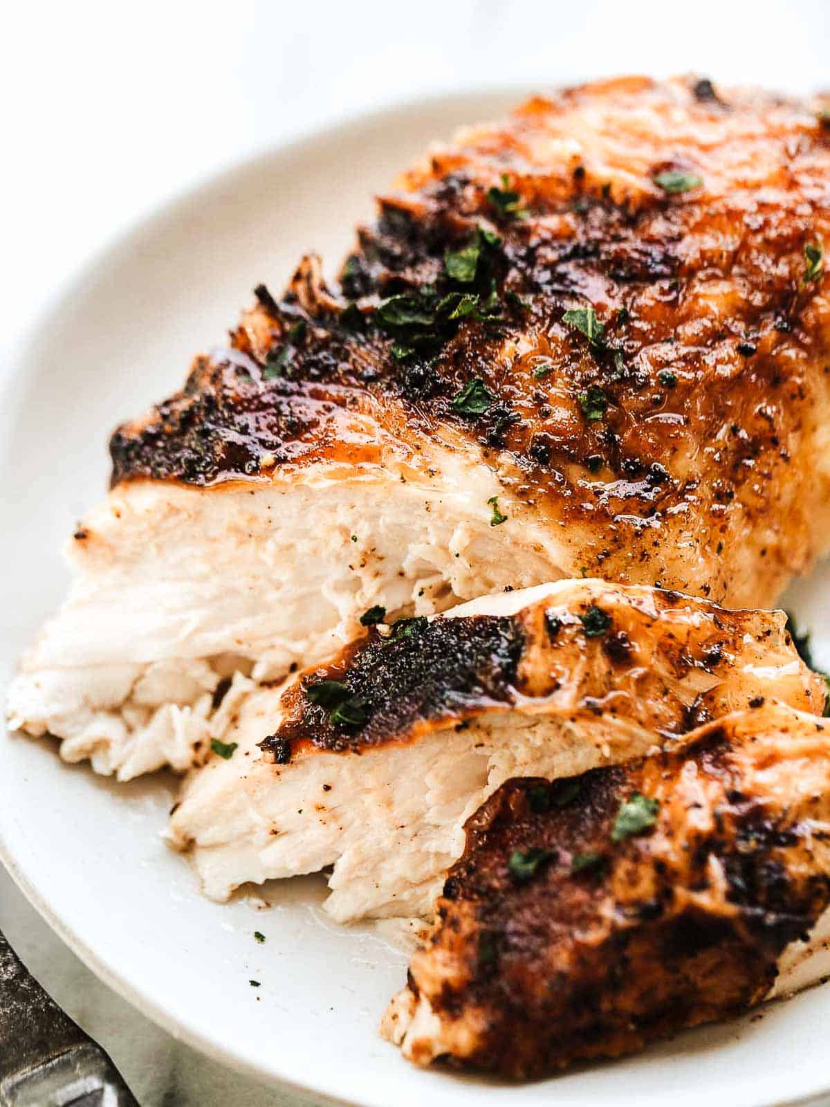 A slice of juicy chicken breast on a plate.
