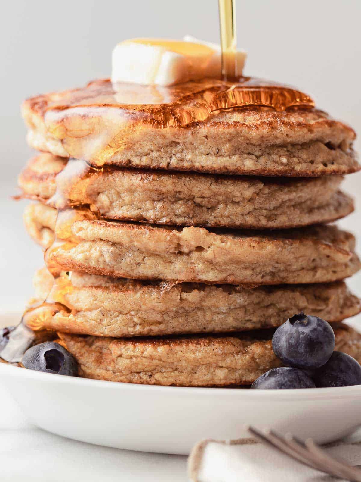 Fluffy protein pancakes stacked on a plate.