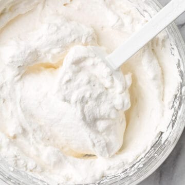 Top view of homemade whipped cream in a bowl.