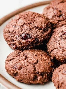Chocolate cherry jam cookies on a plate.