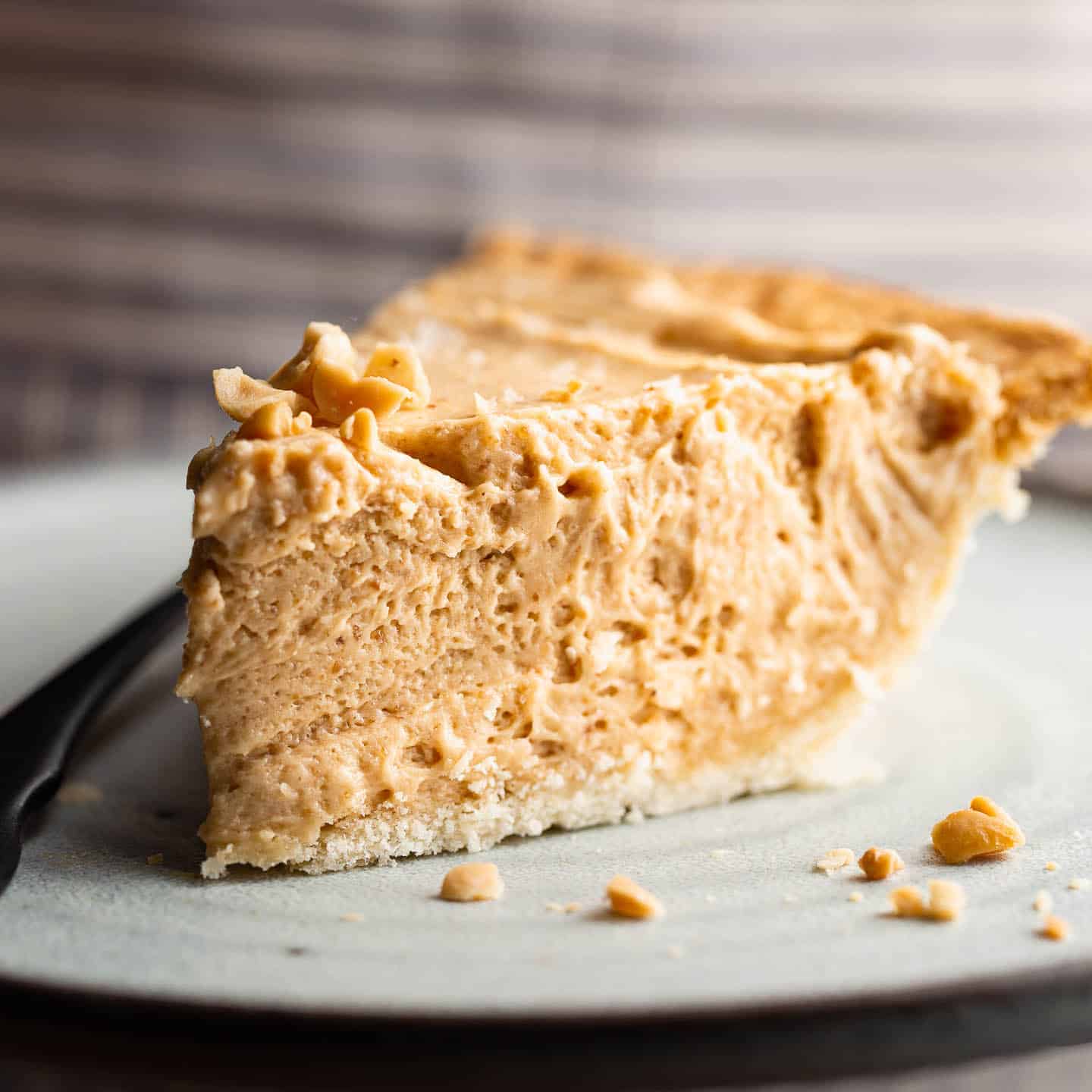 A big slice of peanut butter pie on a plate.