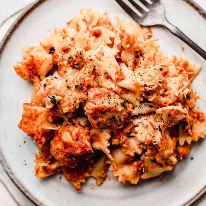 Chicken parmesan casserole plated with a fork.