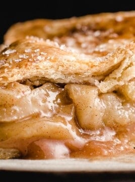 A closeup photo of a slice of apple pie.