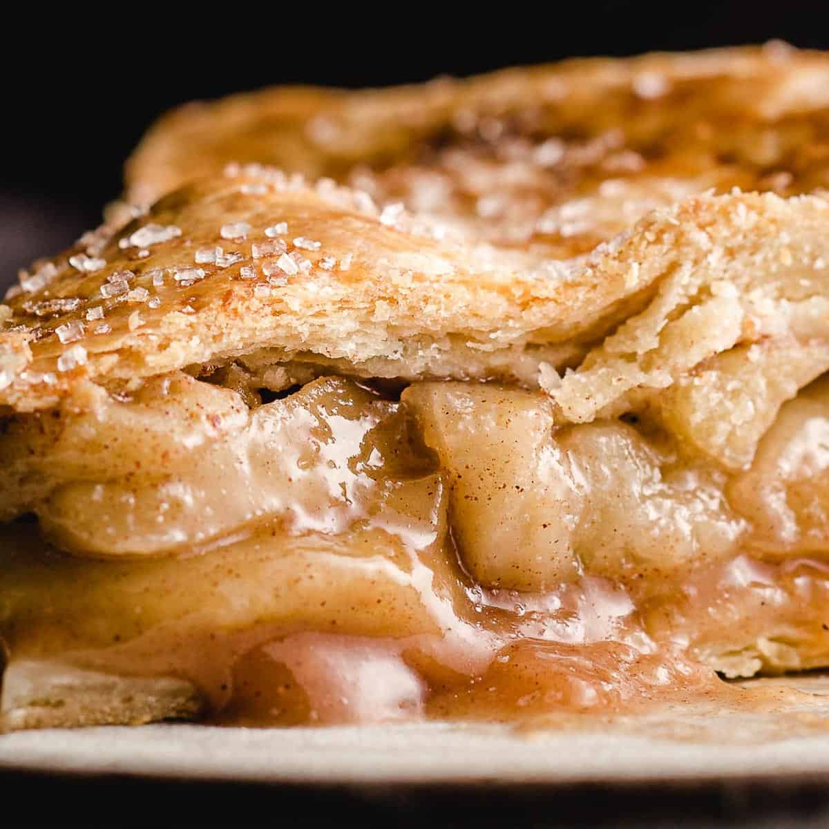 A closeup photo of a slice of apple pie.