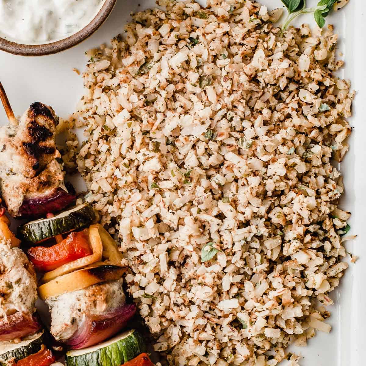 Greek cauliflower rice with chicken kabobs.