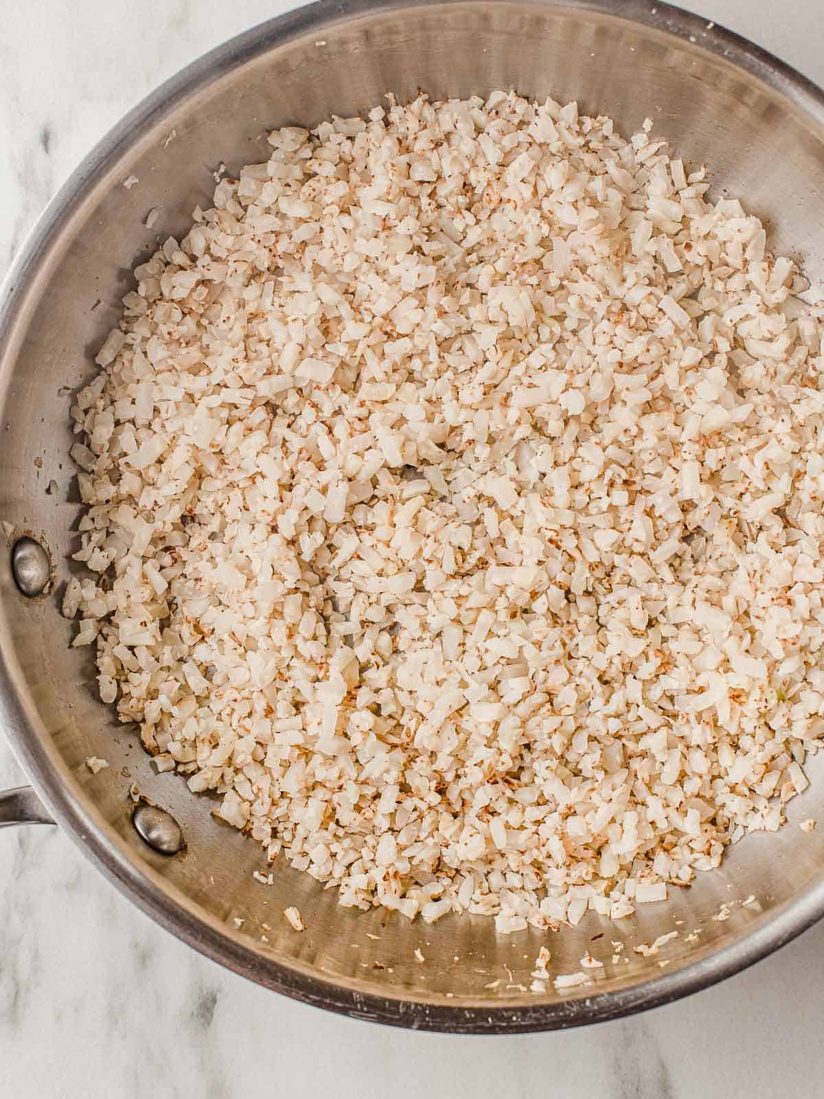 Cauliflower rice in a skillet.