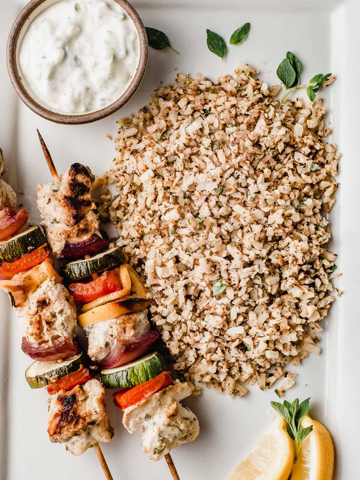Greek cauliflower rice with chicken kabobs.