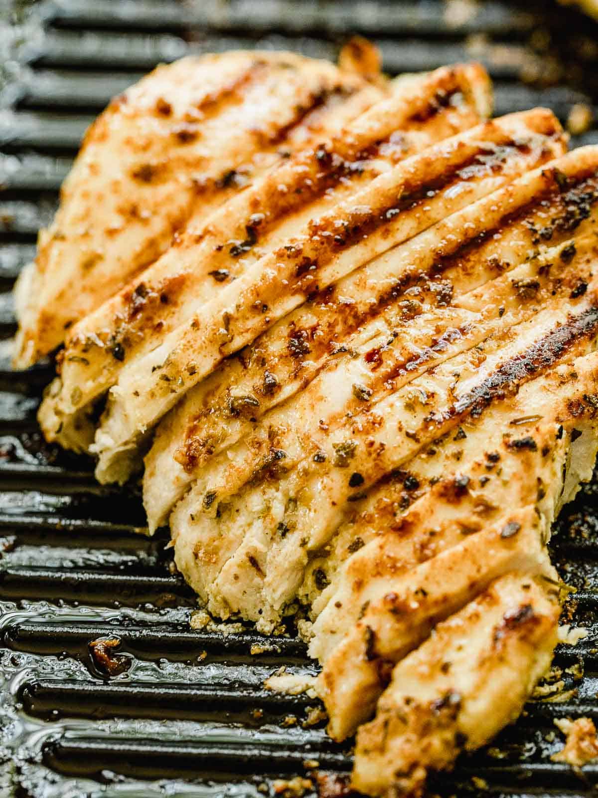 A sliced chicken breast on a grill pan.