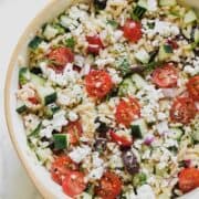 Greek orzo salad in a bowl.