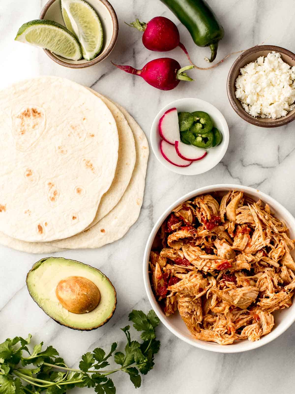 Mexican Shredded Chicken tacos ingredients on a table.