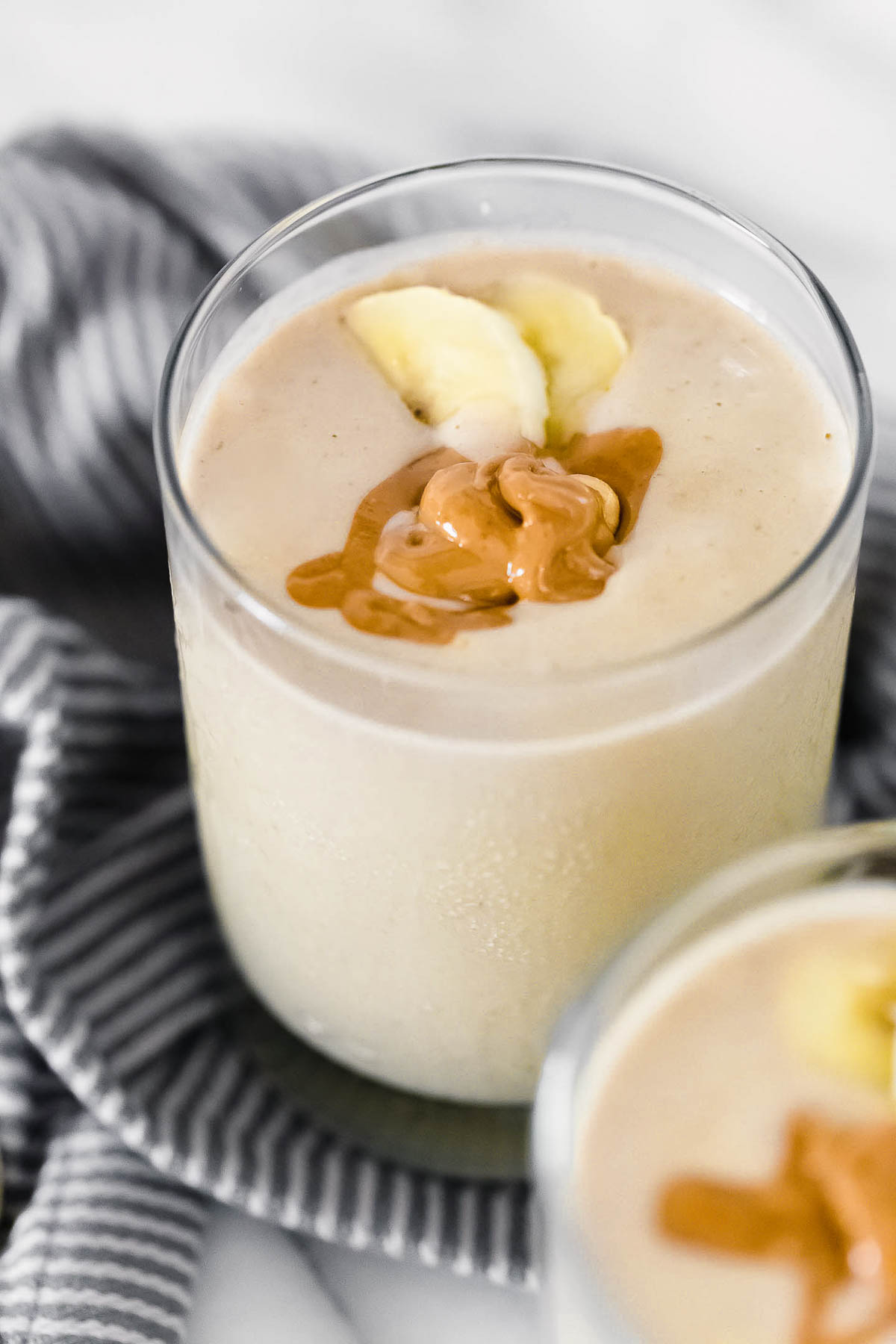 Peanut butter banana smoothies in glasses.