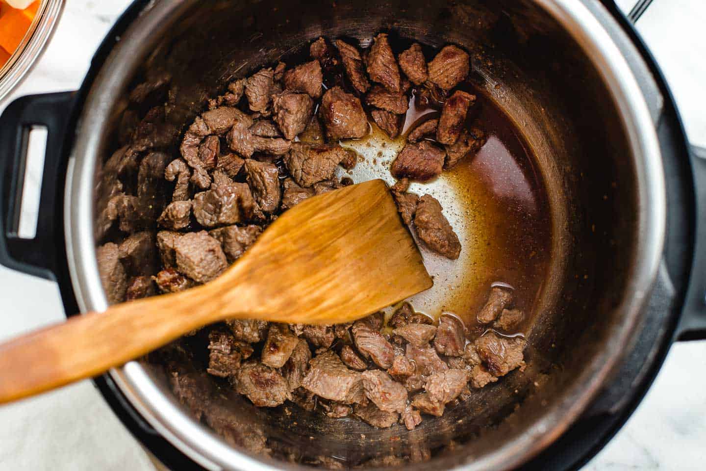 Chunks of beef browning in oil.