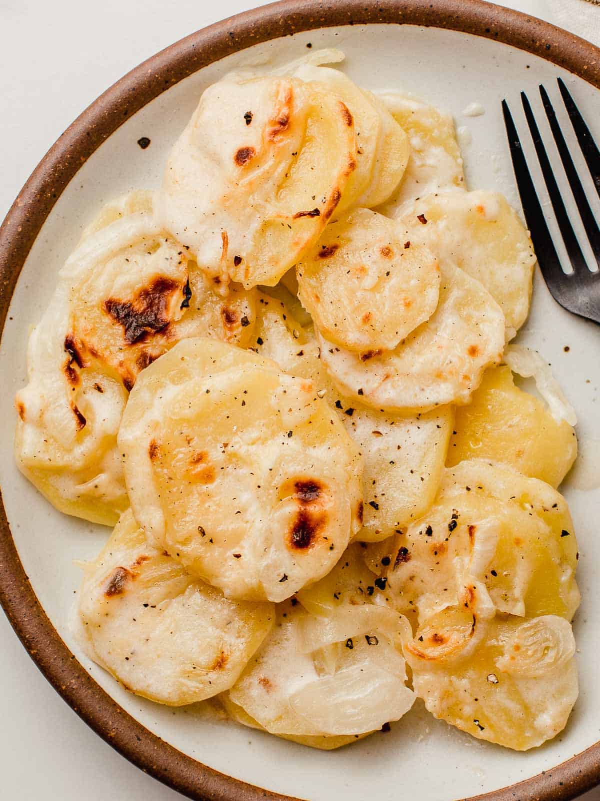 Scalloped potatoes on a plate.