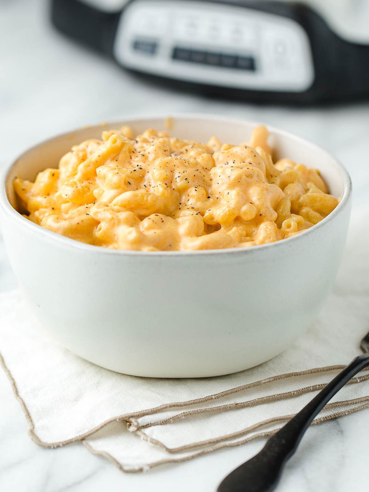 A bowl of crock pot mac and cheese on a table.