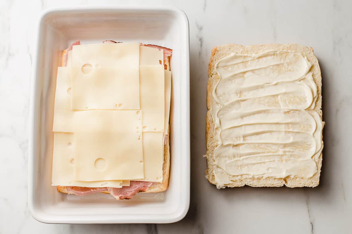 A photo showing how to layer ham and cheese sliders.