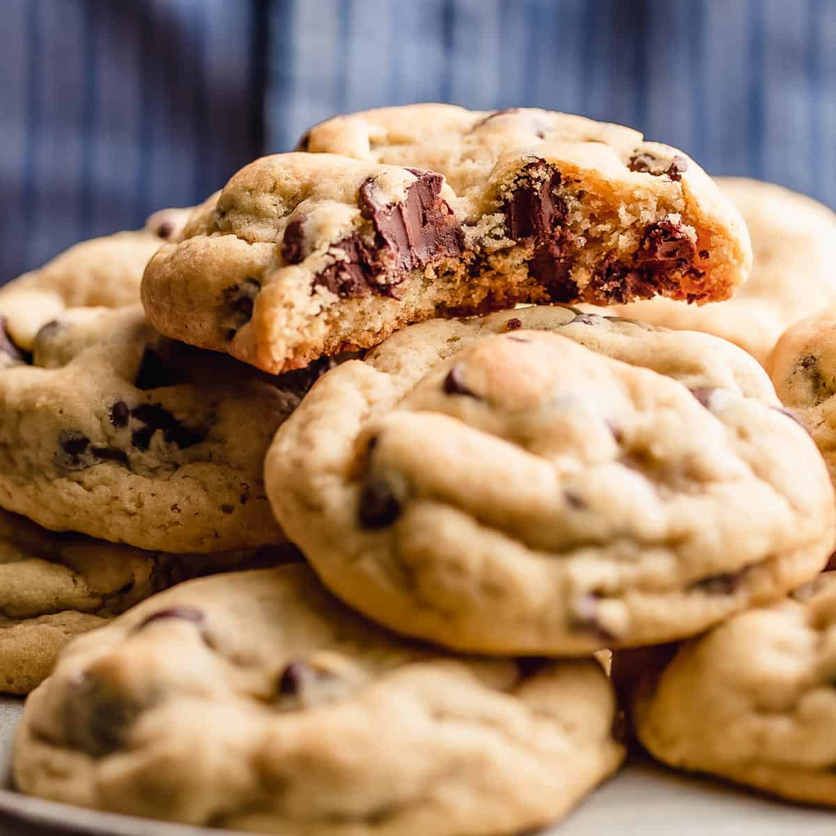 Chocolate chip cookies stacked on a plate.