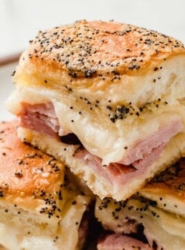Ham and cheese sliders stacked on top of each other.