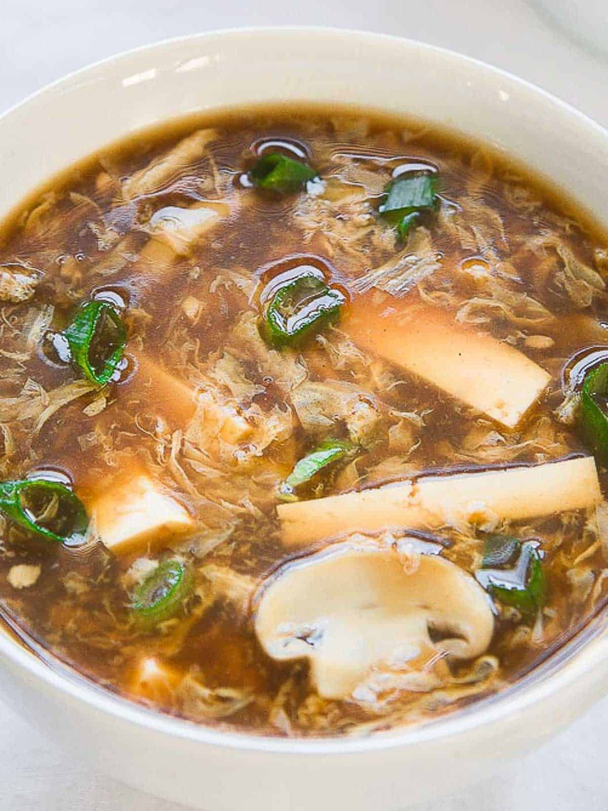 Hot and sour soup in a bowl closeup.