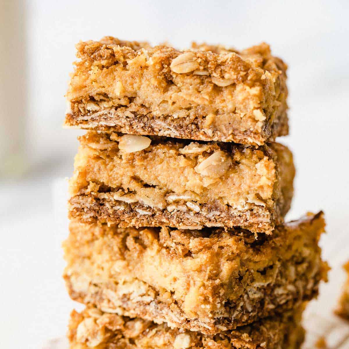 Pumpkin Pie Crumble Bars stacked on top of each other.