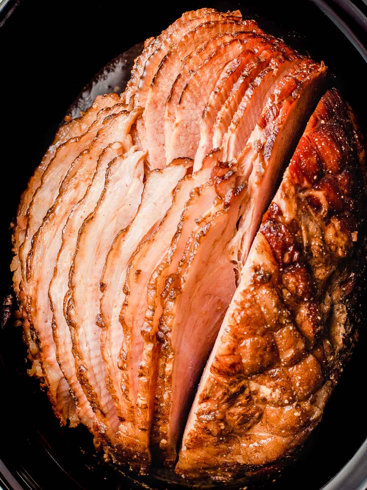 A spiral cut smoked ham in a slow cooker.