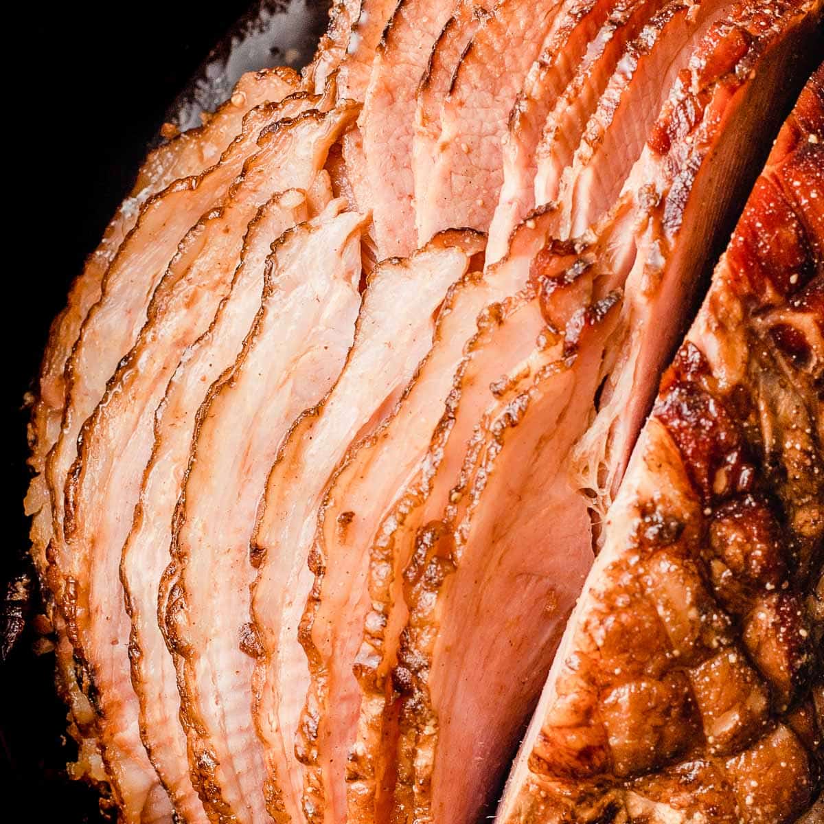 A closeup photo of slow cooker holiday ham with brown sugar and honey glaze.