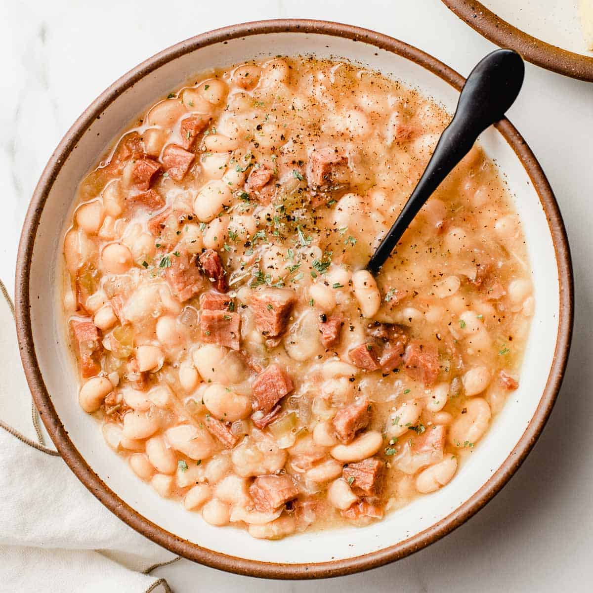 Slow cooker white beans and ham in a bowl.