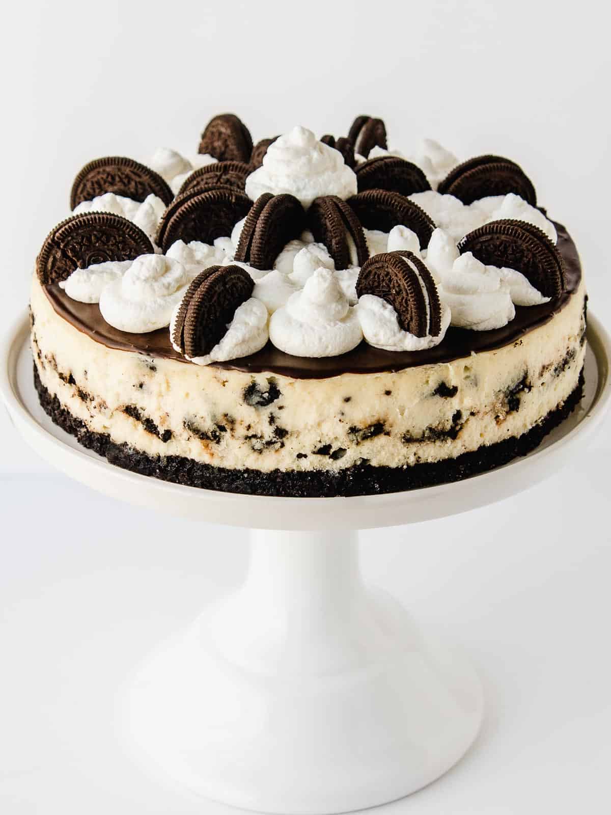 Oreo Cheesecake on a cake stand.