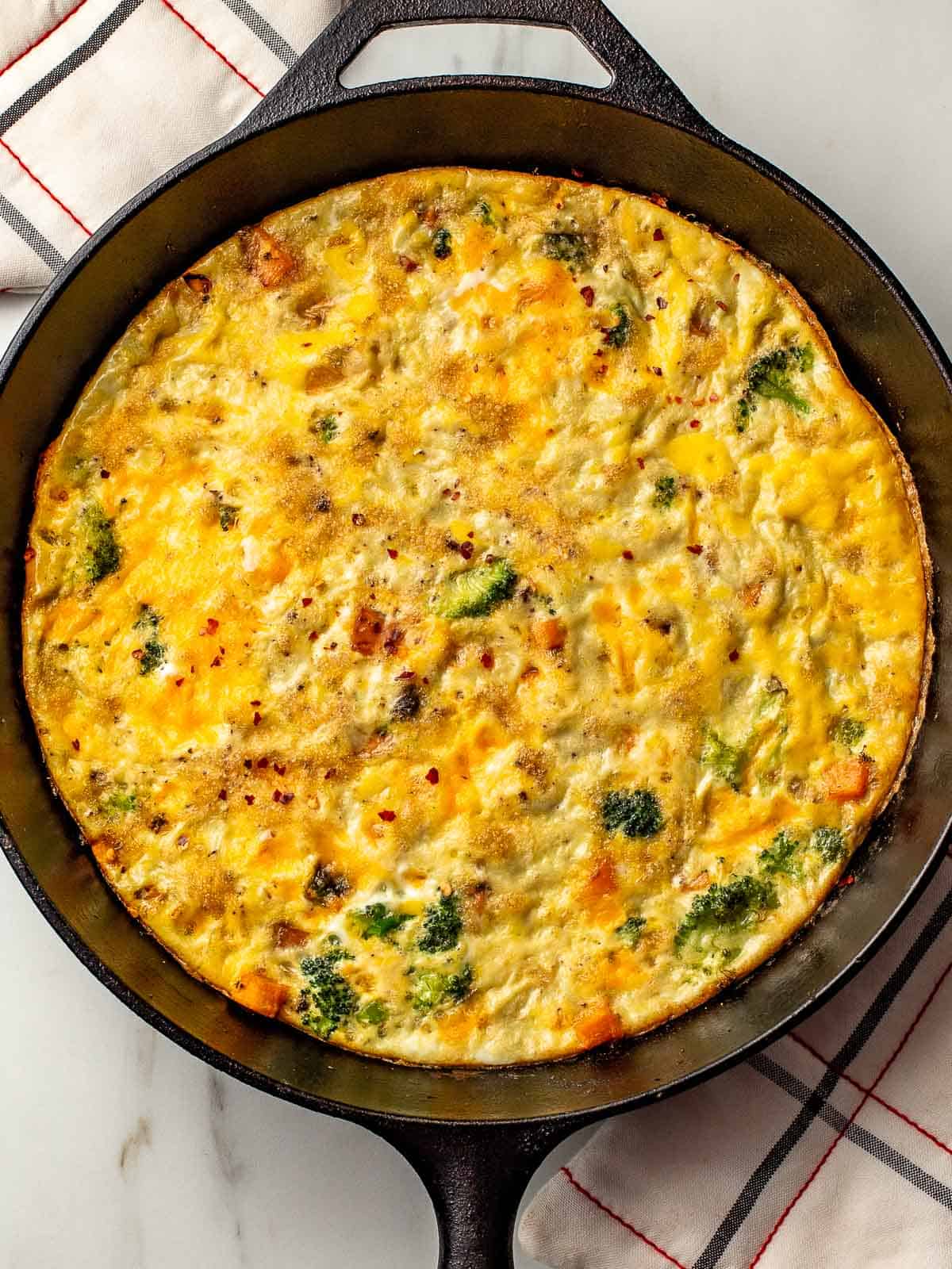 Sweet potato and broccoli frittata in a cast iron skillet.