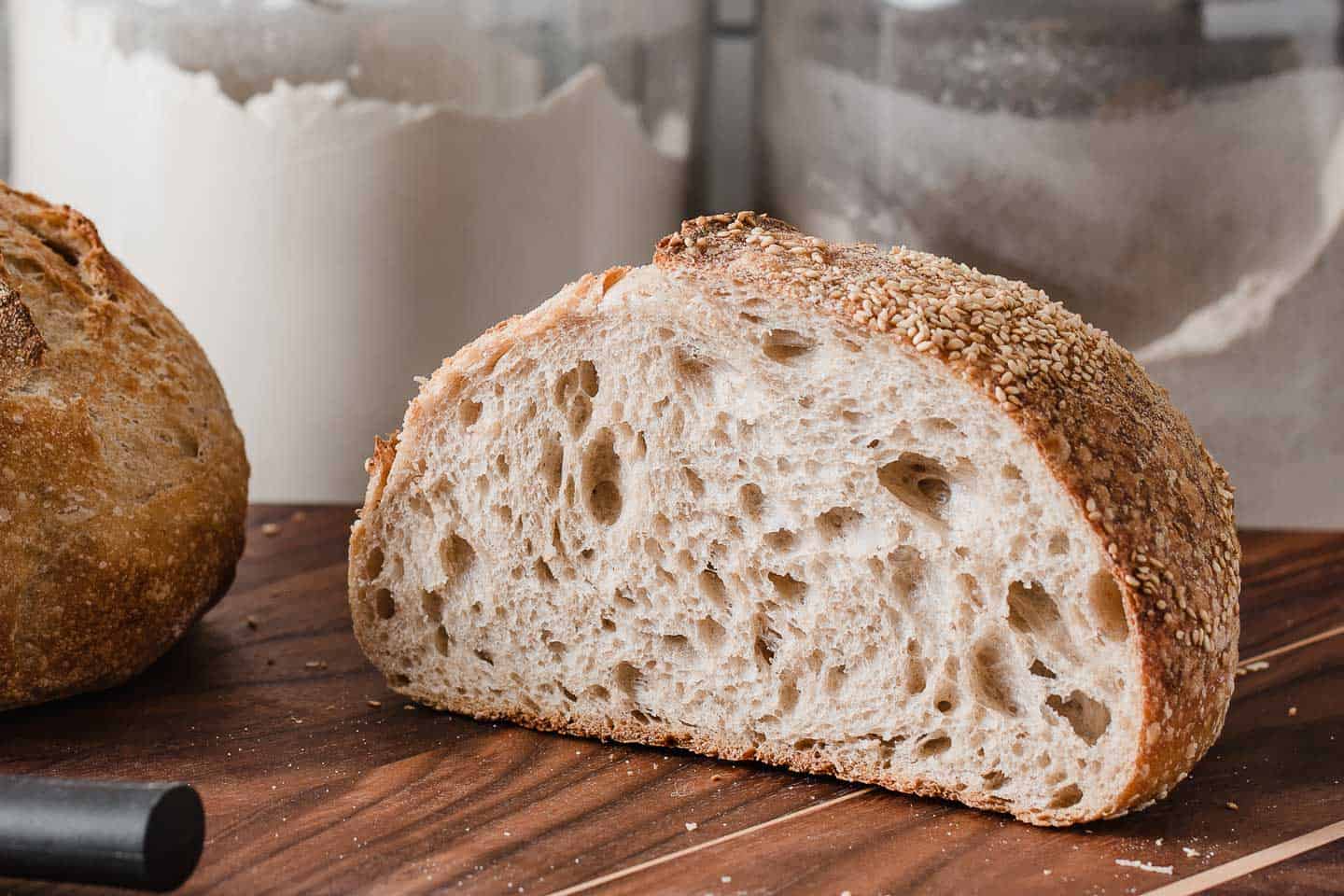 A loaf of bread cut in half to show the open crumb inside.