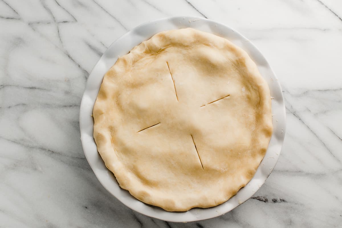 A pie with slits cut in the crust before baking.
