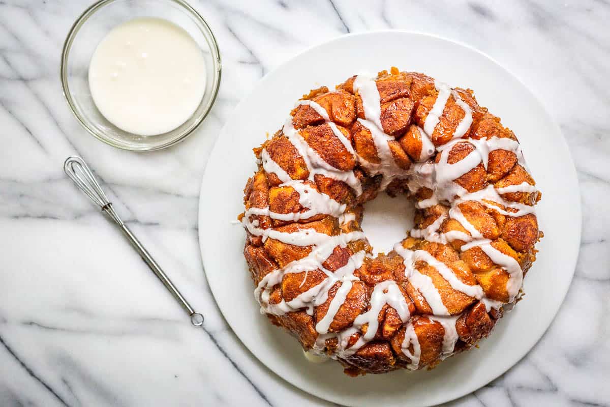Pumpkin monkey bread with glaze drizzled over the top.