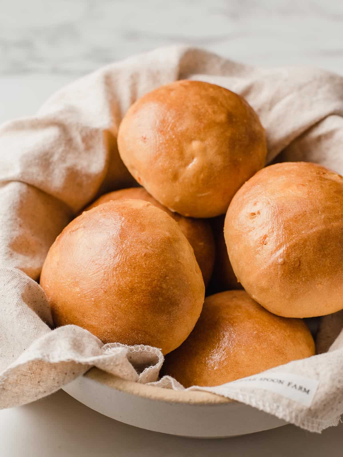 Sourdough sweet potato rolls in a basket.