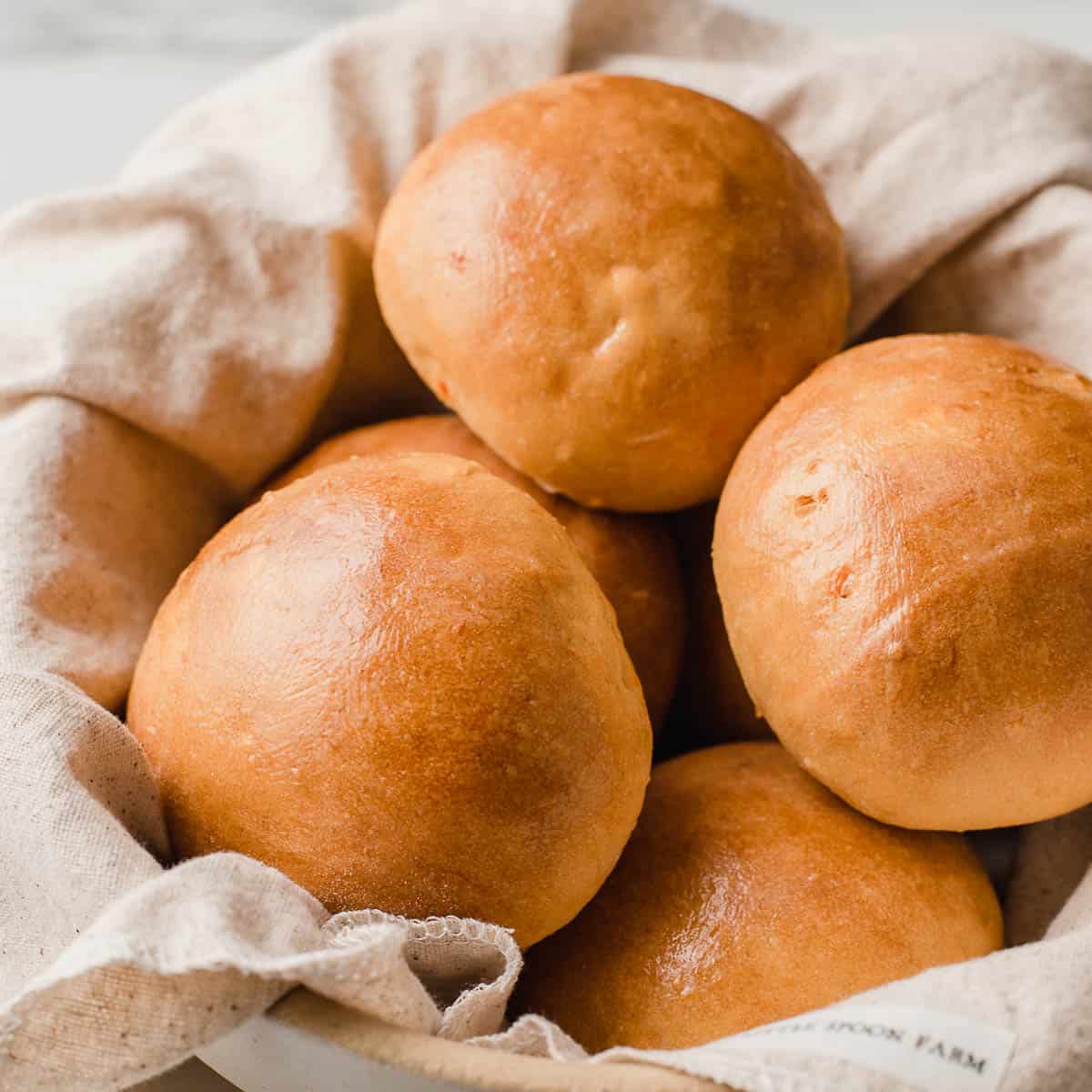 Sourdough sweet potato rolls in a basket.